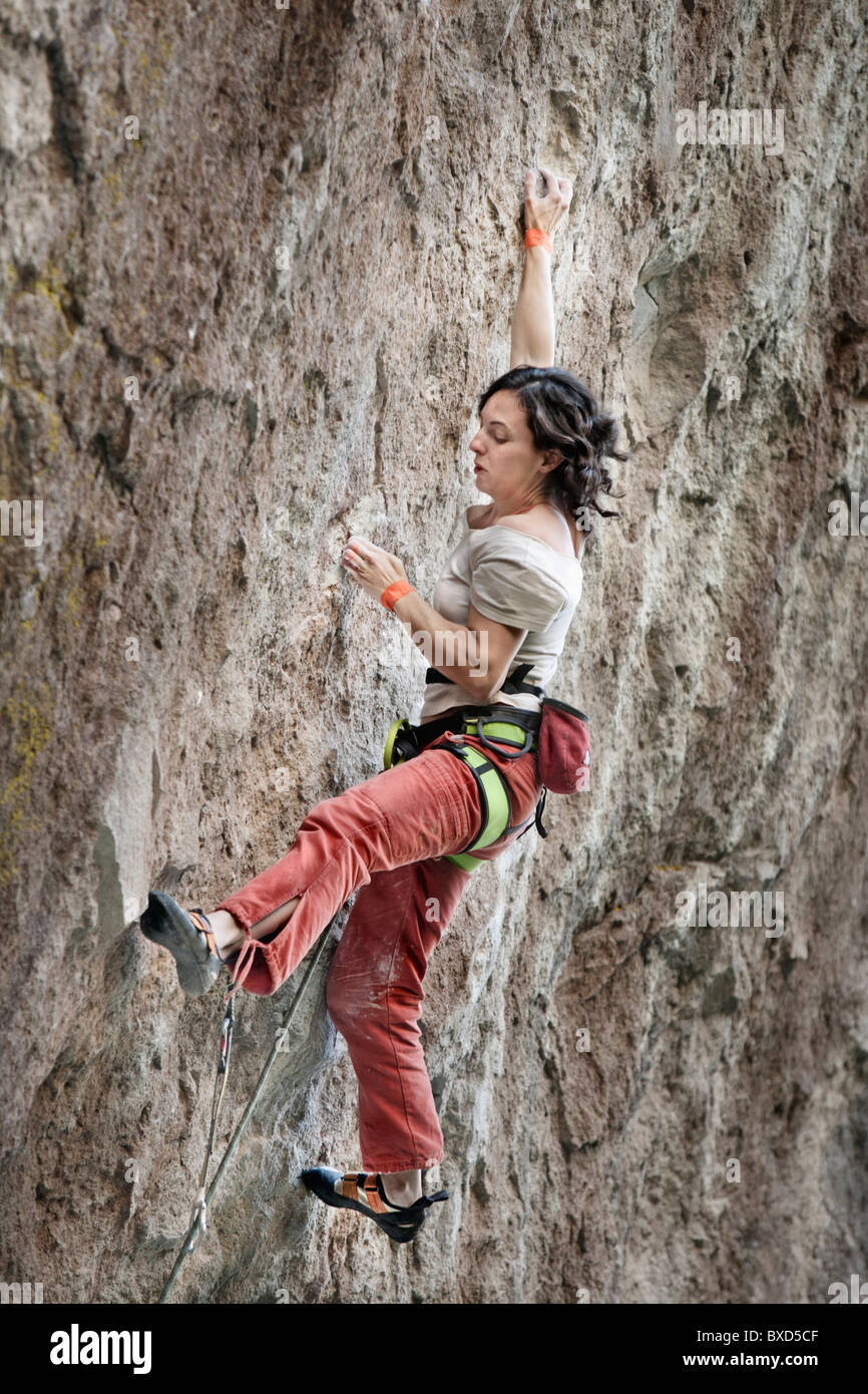 A middle aged woman wearing white tshirt and red pants rock climbing in  Jilotepec, Estado de Mexico, Mexico Stock Photo - Alamy