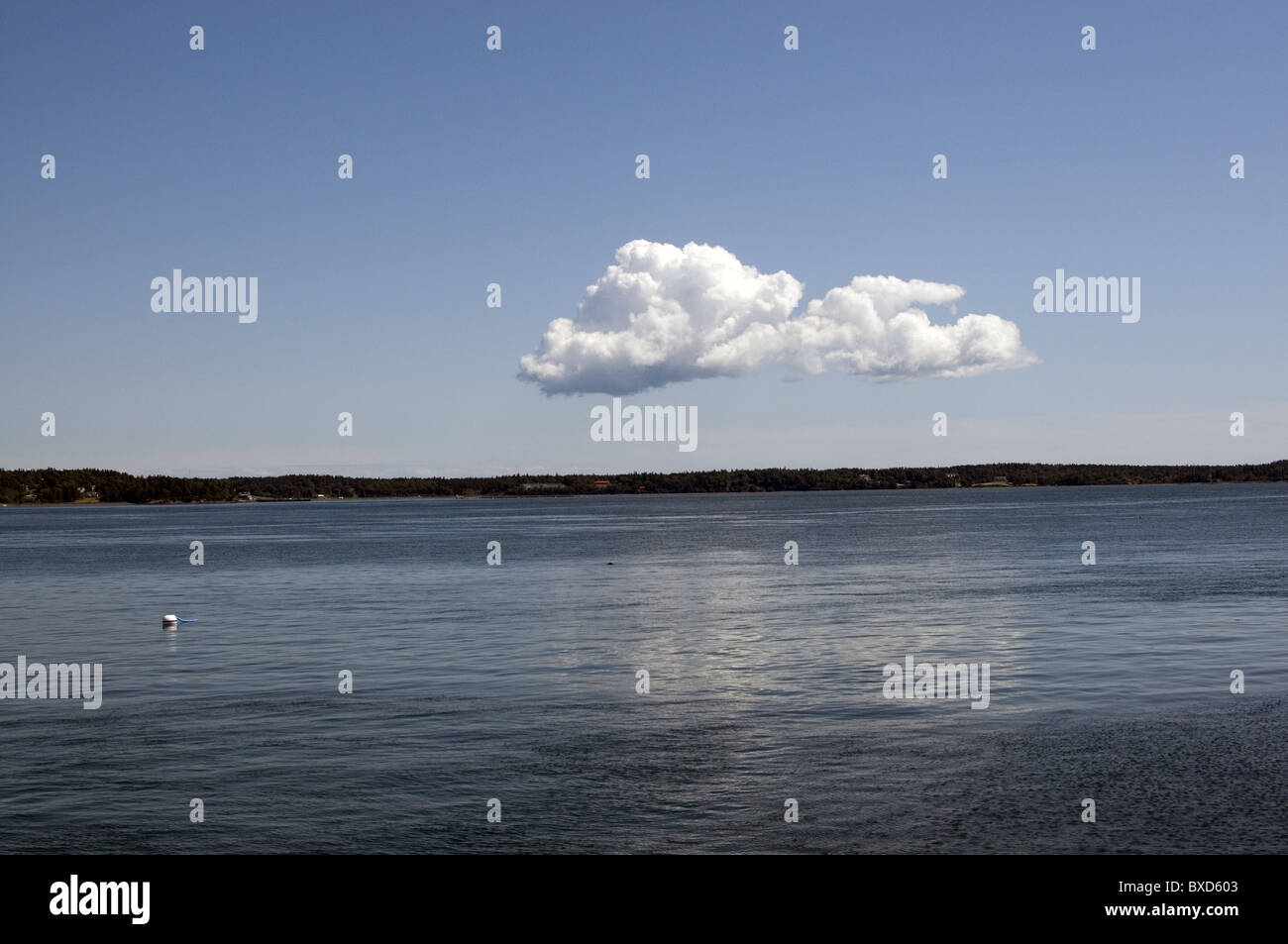 A solitary cloud floating over water Stock Photo - Alamy