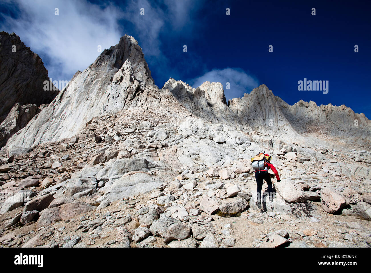 A female hiker scrambles up the mountaineer's route of Mount Whitney, California. Stock Photo
