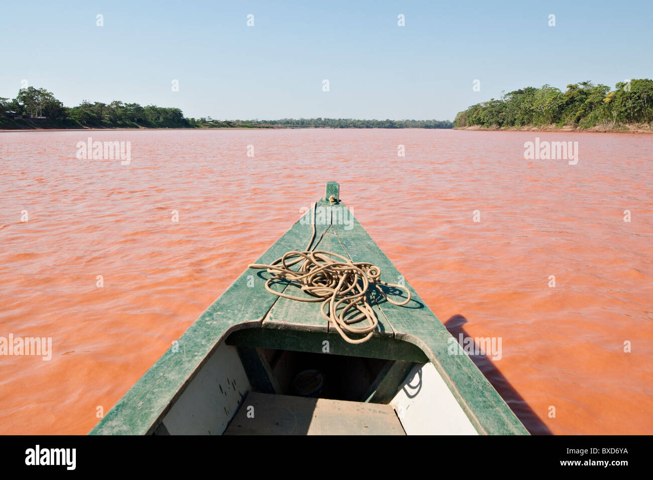 A wooden canoe made of Eucylptus tree floats in the amazon river and connecting tributary rivers in the rainforest. Stock Photo