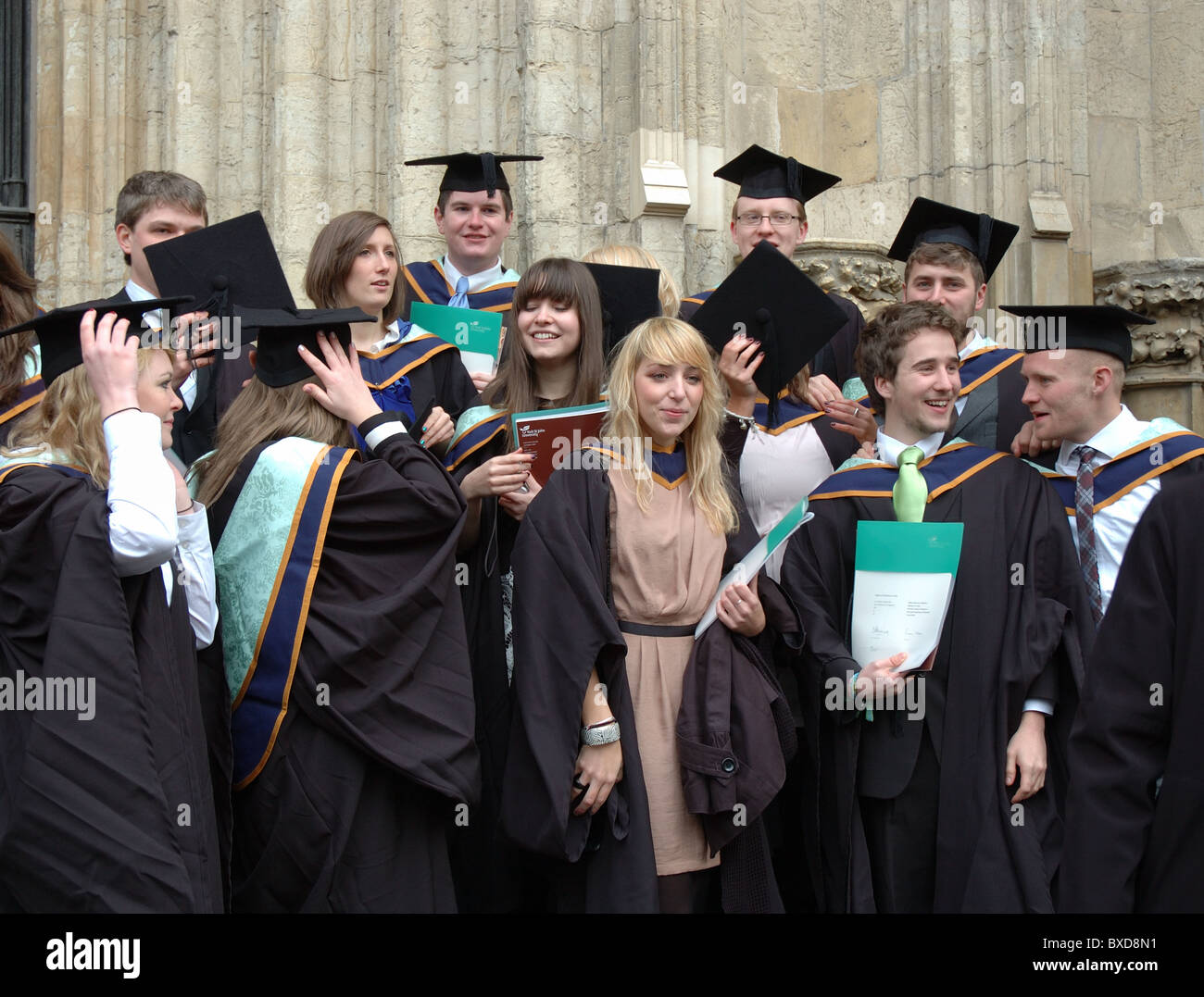graduates from York St John University celebrating their success outside York Minster, York, England, UK Stock Photo
