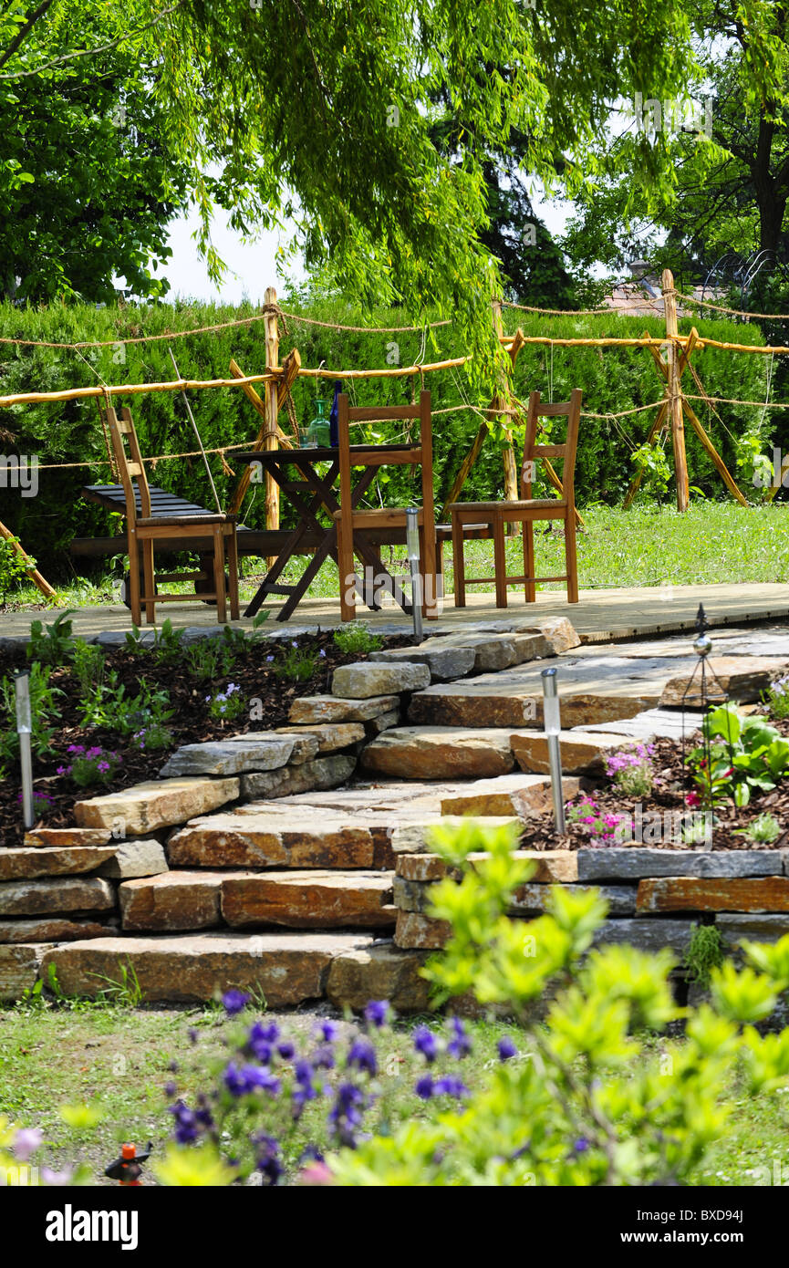 nature garden with stone wall Stock Photo - Alamy