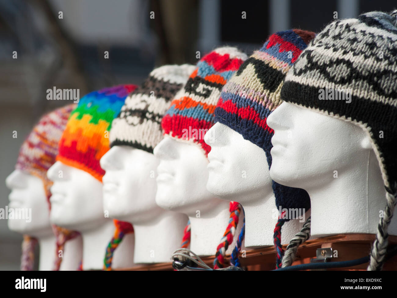 Colourful woolly hats for sale in Worcester's high st on a cold winter's day. England December 2010. Stock Photo