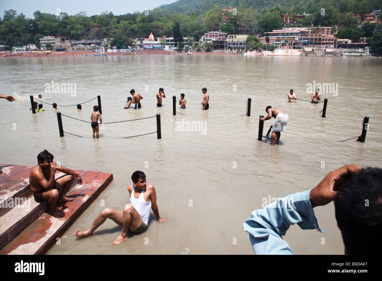 Hindu devotee pilgrims bathe in the Ganges river in Rishikesh, Uttarakhand, India. Stock Photo