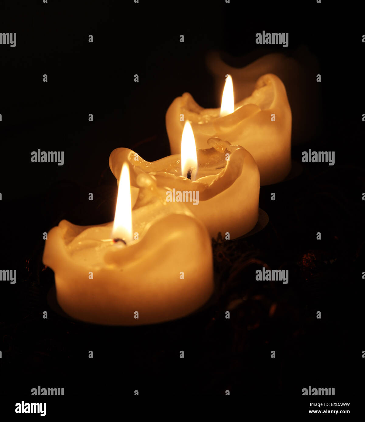 A row of burning candles Stock Photo Alamy