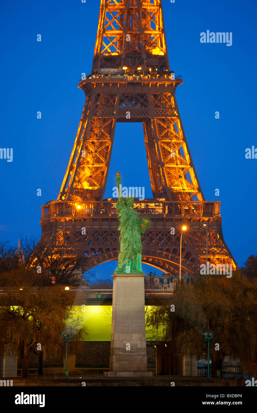 Paris, Tour Eiffel and Statue of Liberty at Night Stock Photo