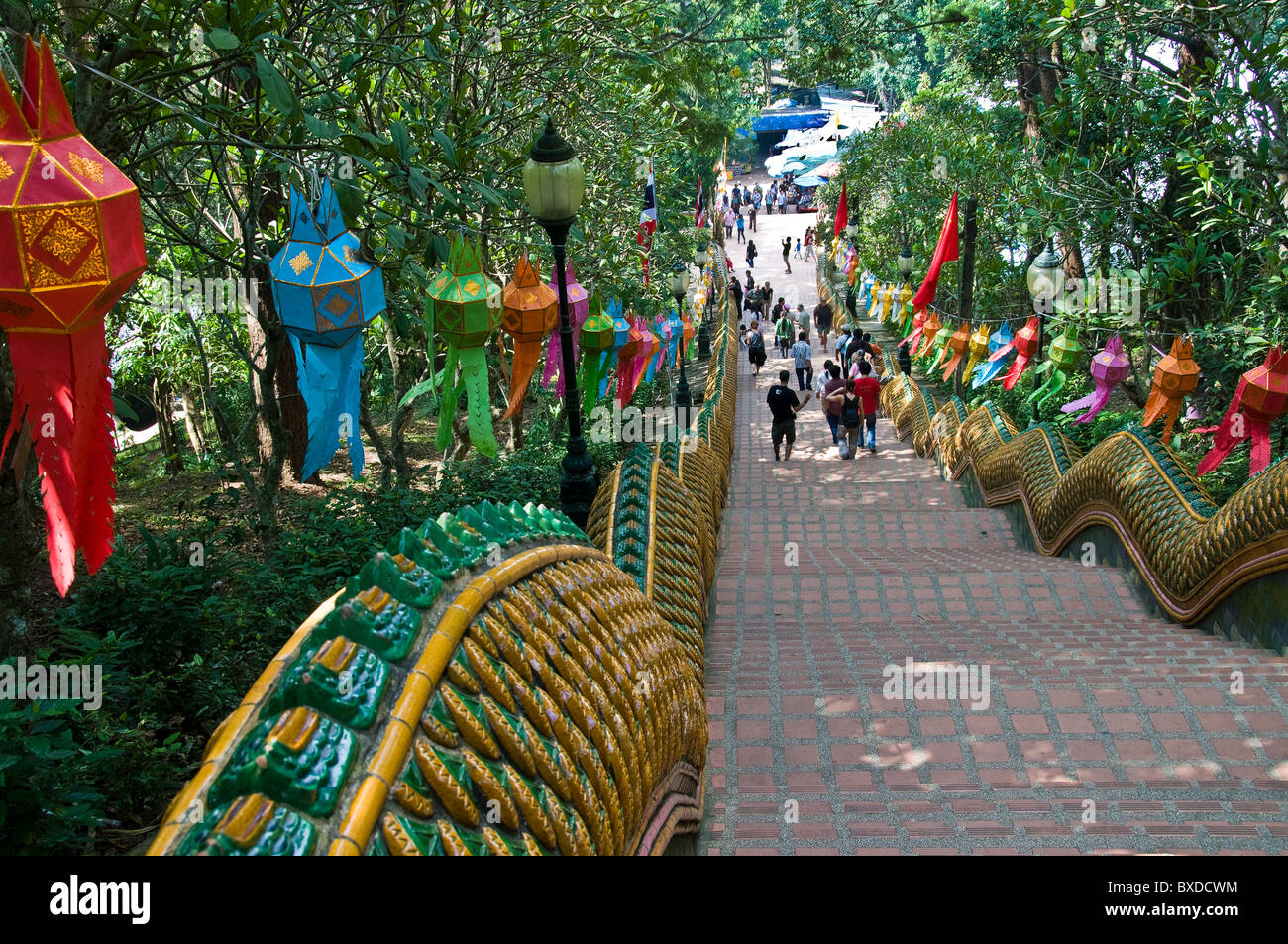 People climbing and descending the 300 steps up to Wat Phra That Doi Suthep in Chiang Mai in Thailand. Stock Photo