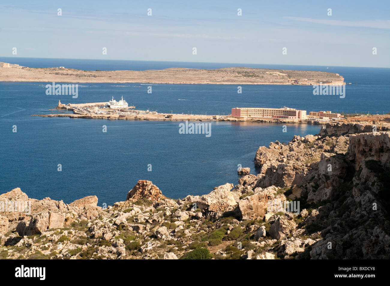 View over Cirkewwa, North West Malta with the island of Comino behind from Paradise Bay Stock Photo