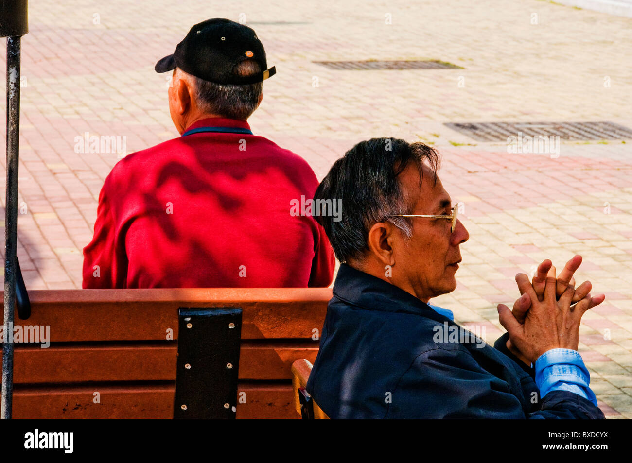 Old men sitting on benches hi-res stock photography and images - Alamy