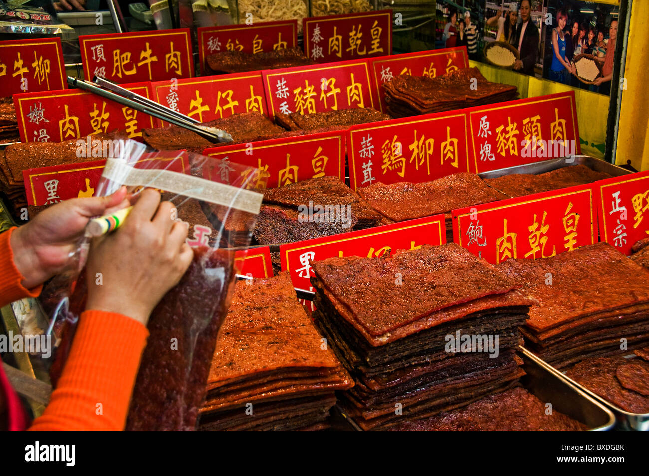 Selling dried jerky slabs on street in downtown Macau Hong Kong China