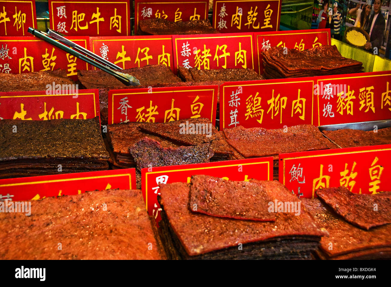 Selling dried jerky slabs on street in downtown Macau Hong Kong China