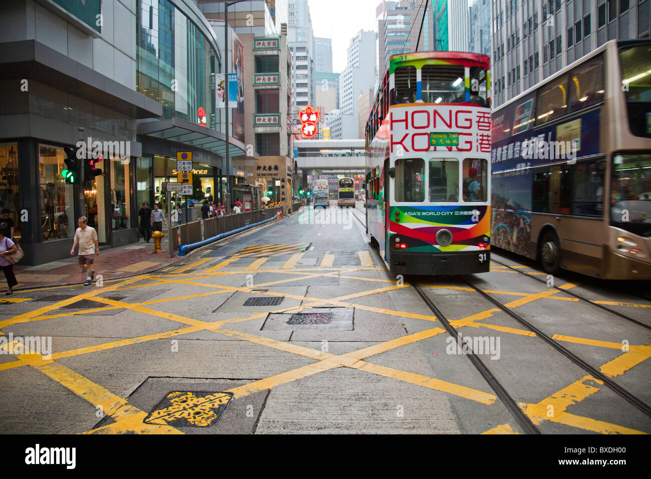 Iconic travel in Hong Kong, the tram is almost an emblem or symbol of this island trams road roads  buildings modern cities Stock Photo