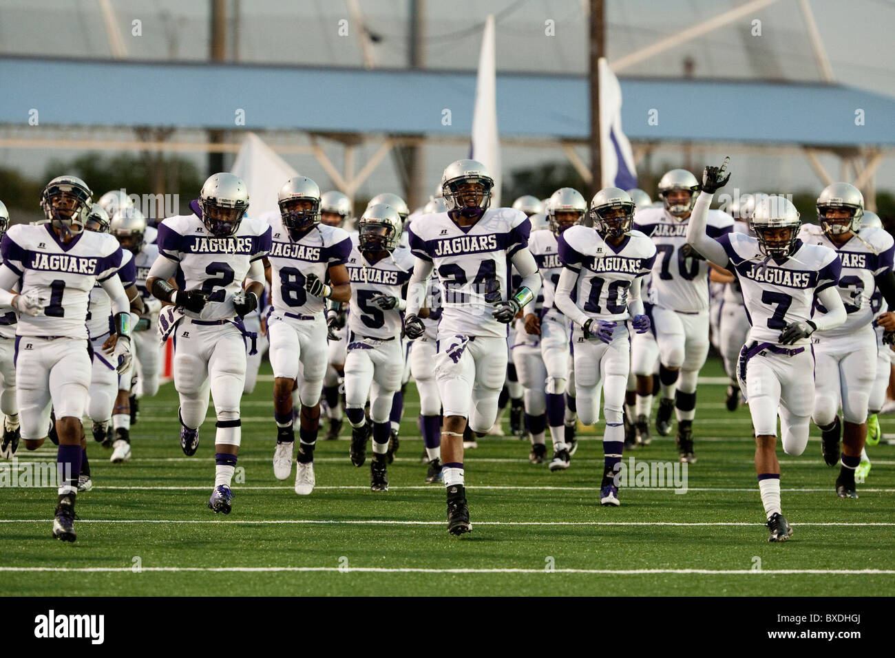 American high school football players run unto the field before kickoff at a game in Austin, Texas USA Stock Photo