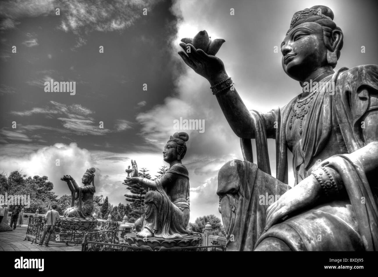 Hong Kong, Lantau island seated bronze statues making offerings to  Buddha, Stock Photo