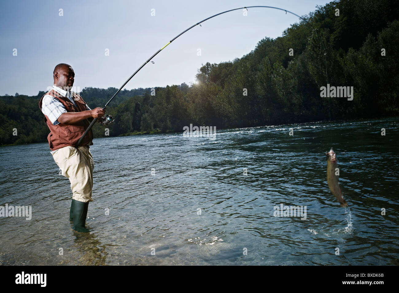 Black man catching fish in stream hi-res stock photography and images -  Alamy