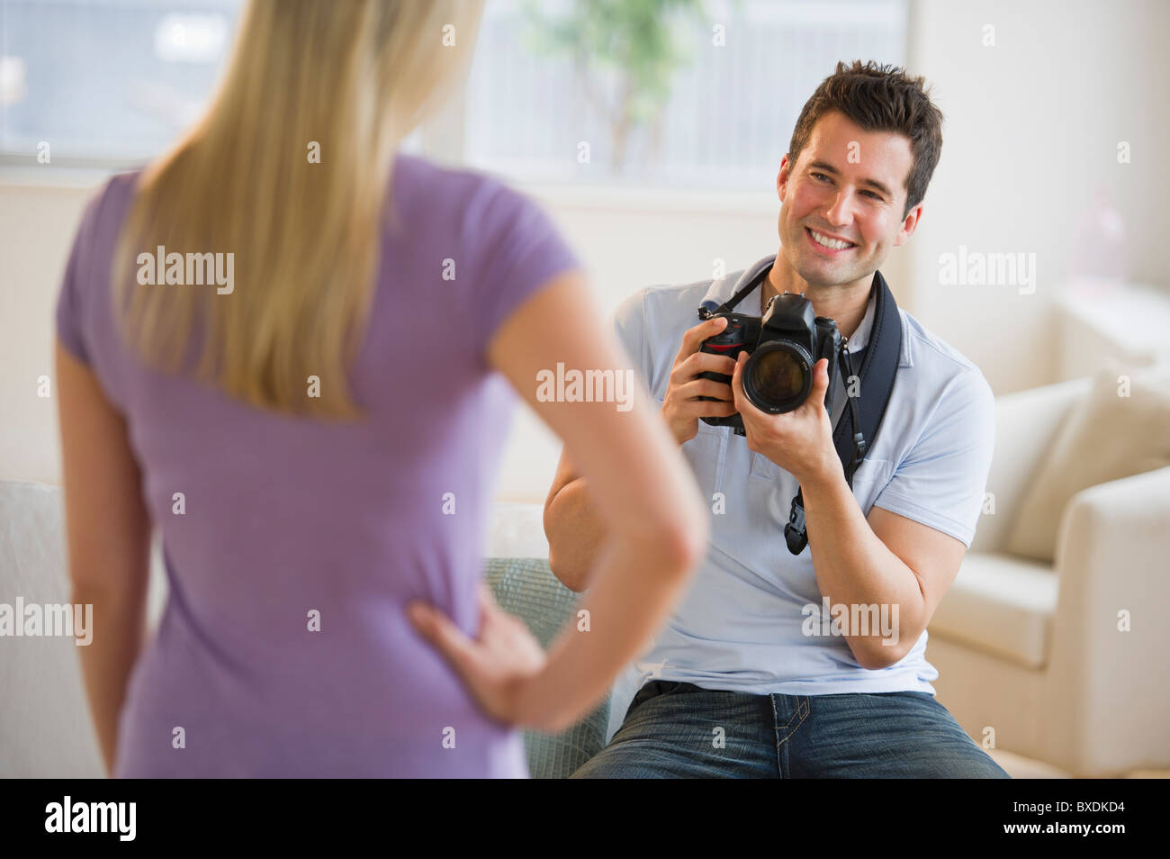 Man taking photograph of woman Stock Photo