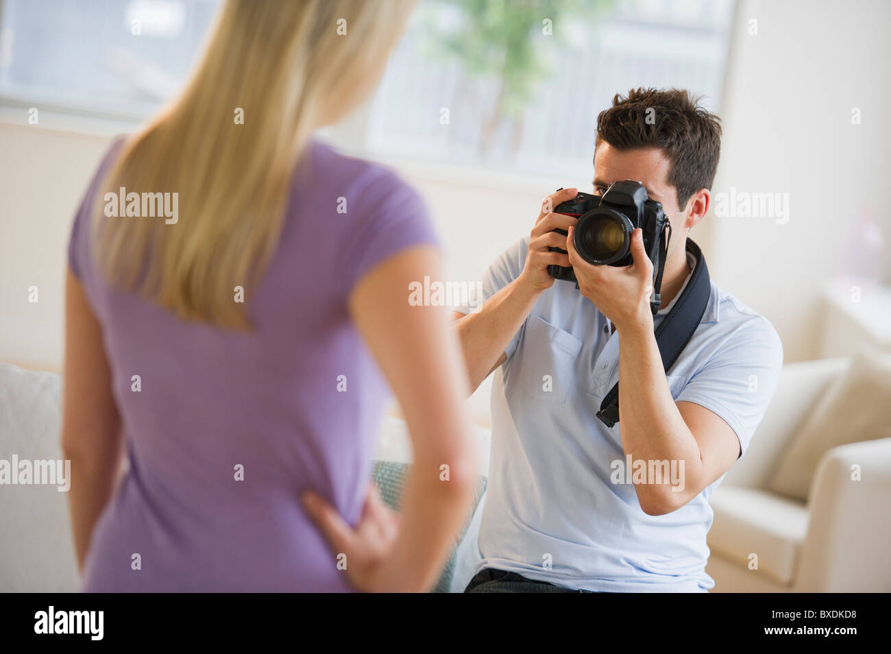Man taking photograph of woman Stock Photo