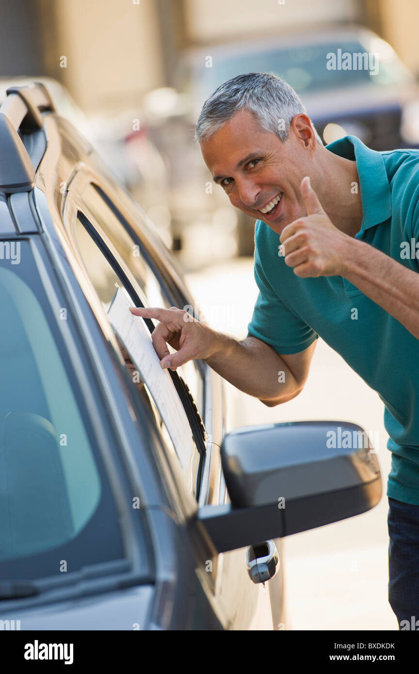 Man looking at new car Stock Photo