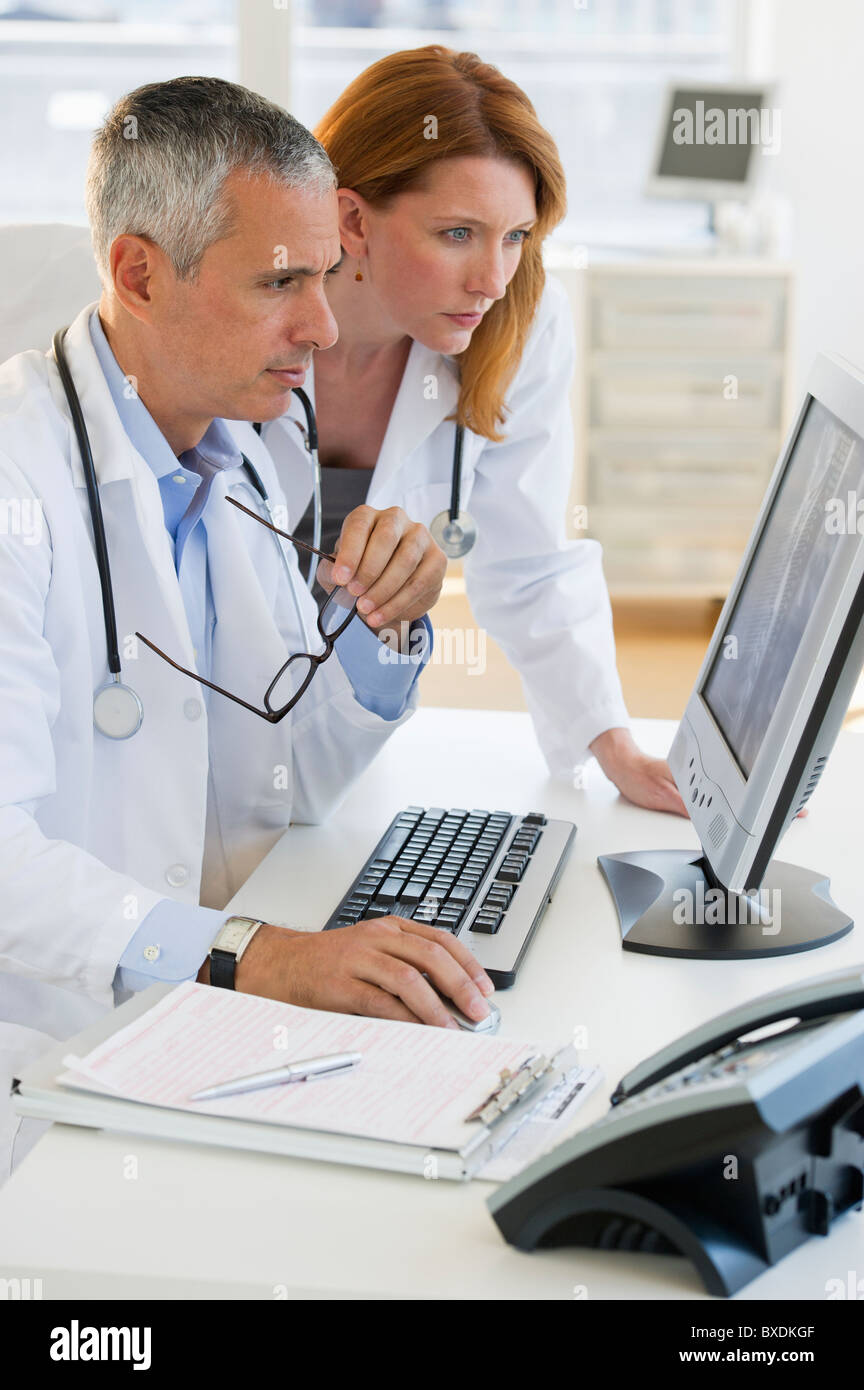 Healthcare professionals looking at computer Stock Photo