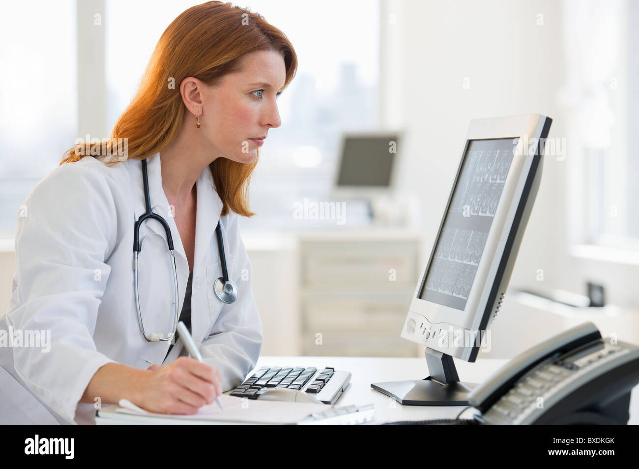 Doctor working at computer Stock Photo