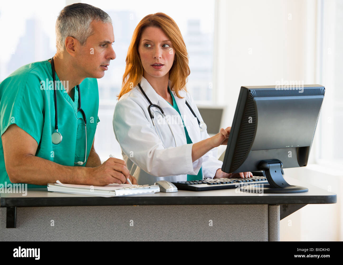 Healthcare professionals working at computer Stock Photo