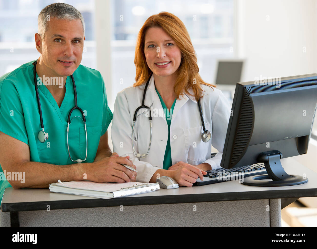 Healthcare professionals working at computer Stock Photo
