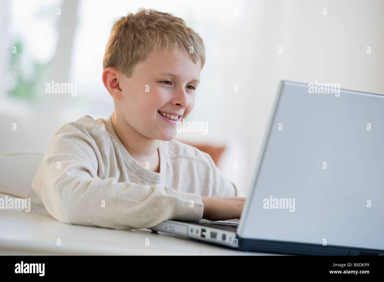 Young boy looking at laptop Stock Photo