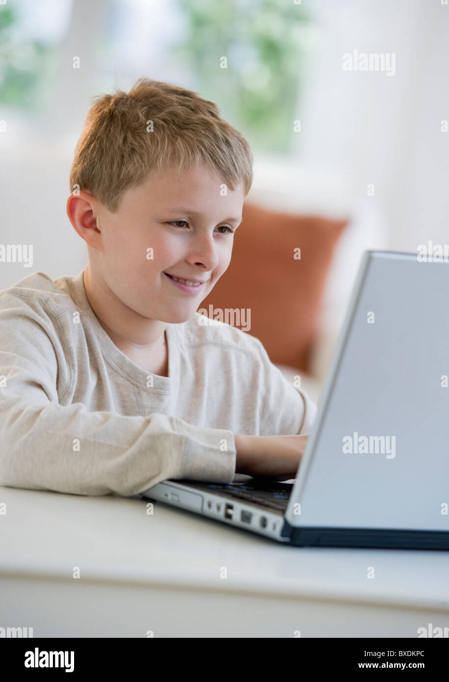 Young boy looking at laptop Stock Photo