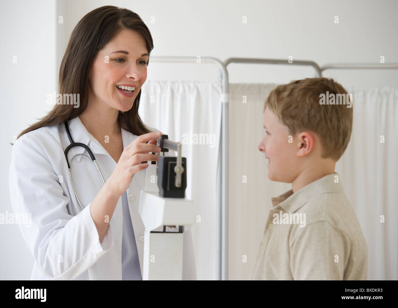 Young boy and doctor in examination room Stock Photo