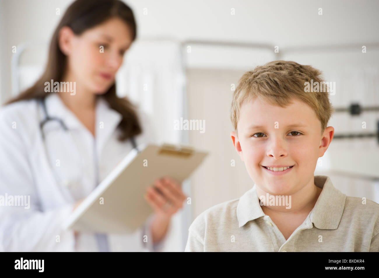 Young boy and doctor in examination room Stock Photo