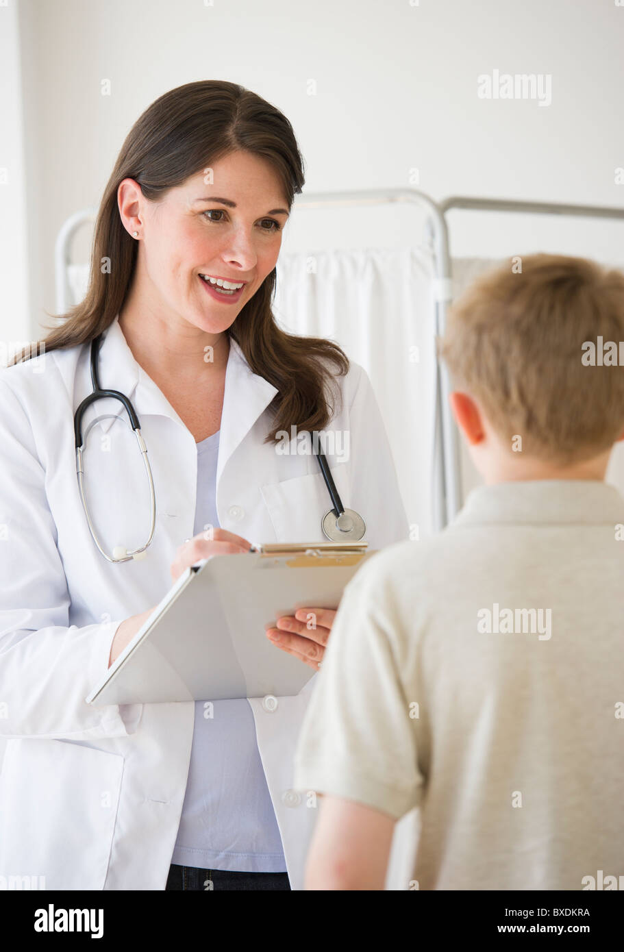 Young boy and doctor in examination room Stock Photo