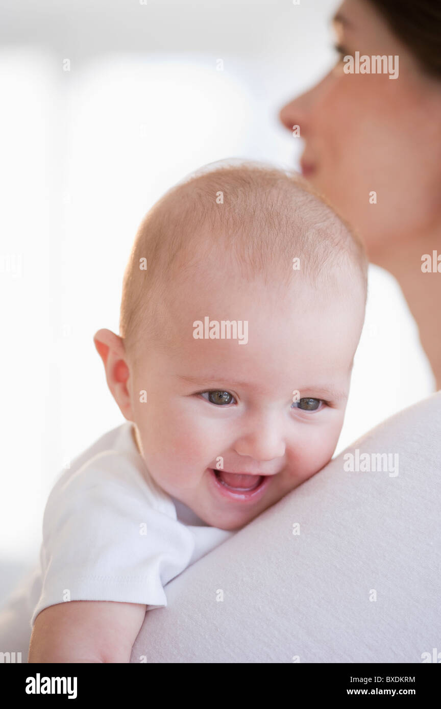 Baby being held by mother Stock Photo