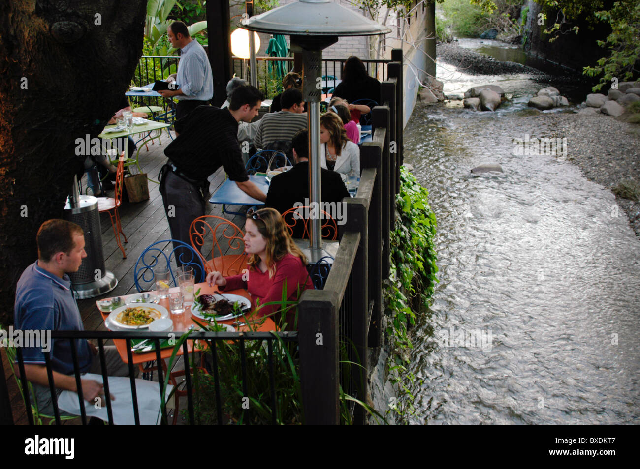 A couple dine at a cafe along San Luis Creek in San Luis Obispo, CA Stock Photo