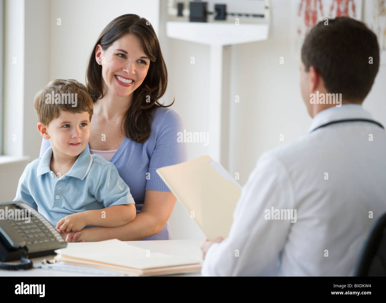Doctor talking to woman and her son Stock Photo