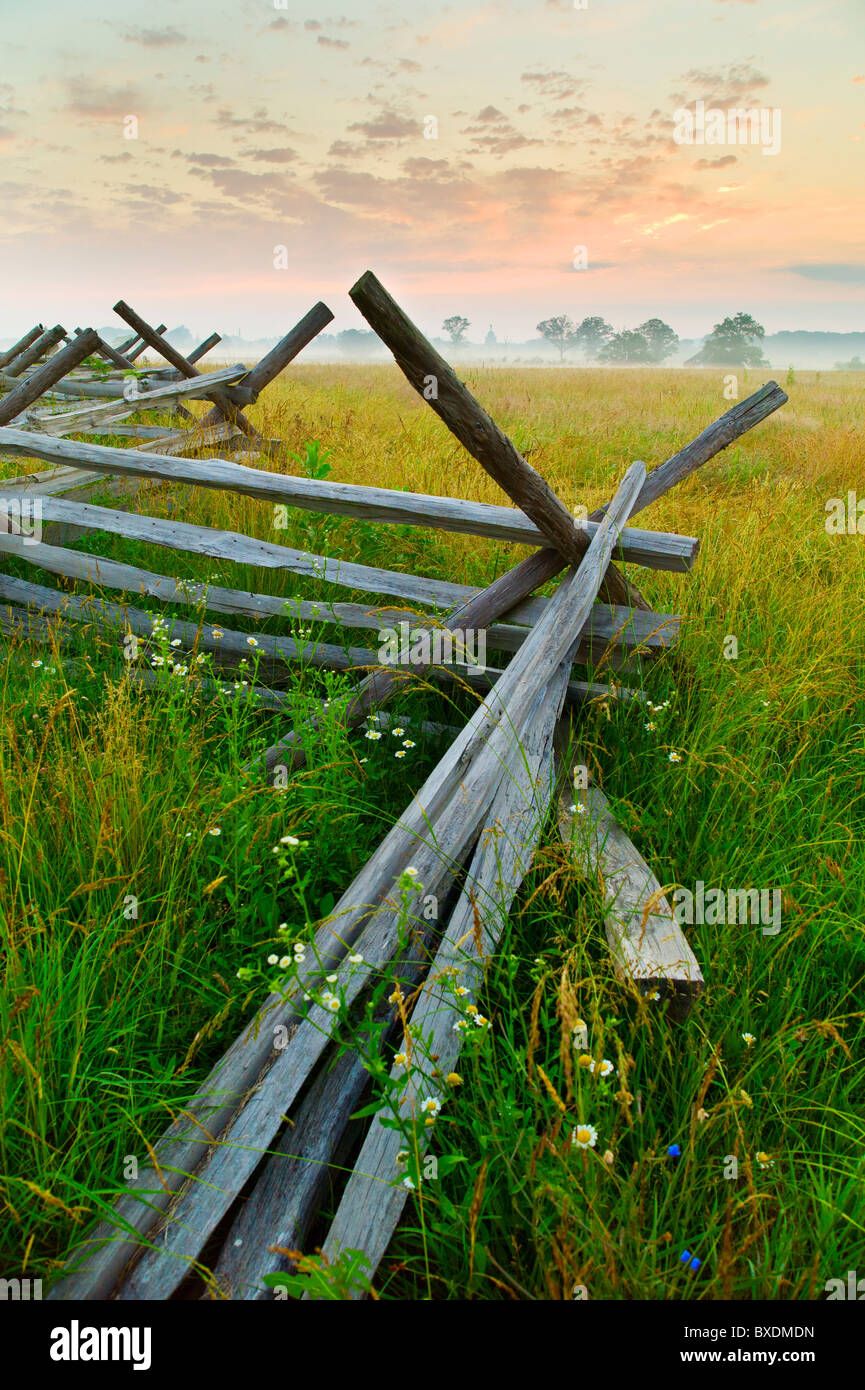 Rustic fence in field Stock Photo
