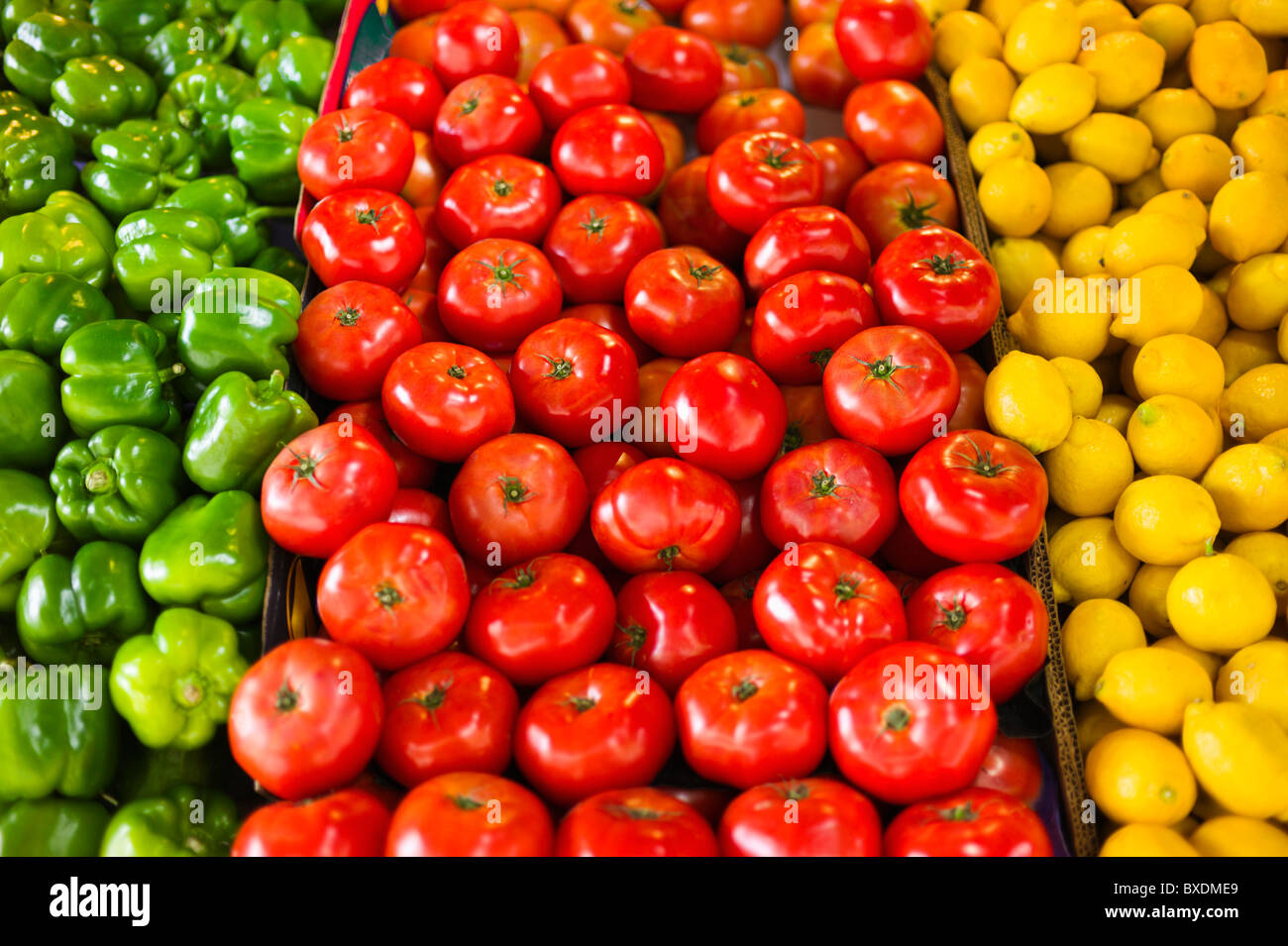 Display of peppers tomatoes and lemons Stock Photo Alamy
