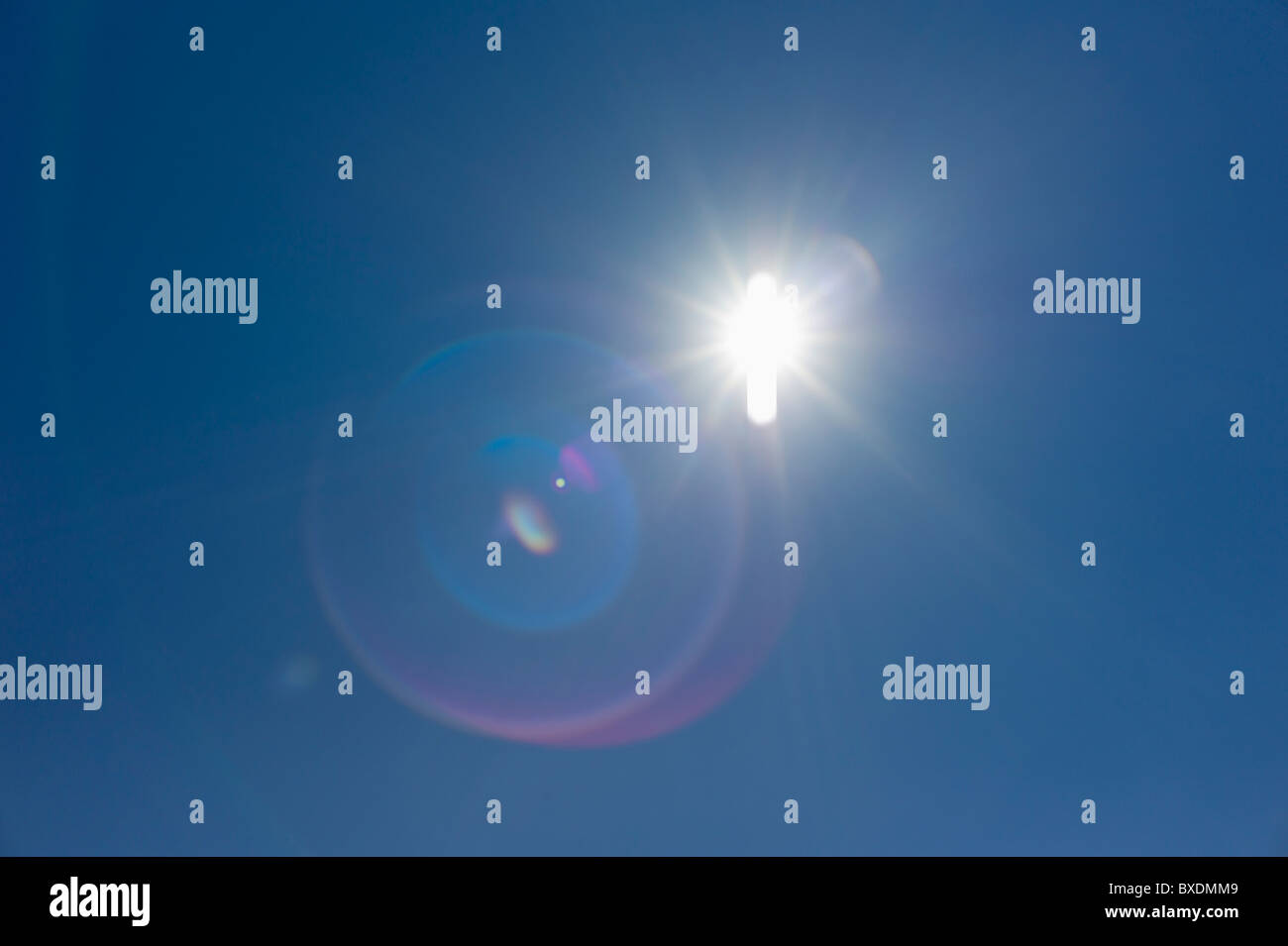 Flare of light in blue sky Stock Photo