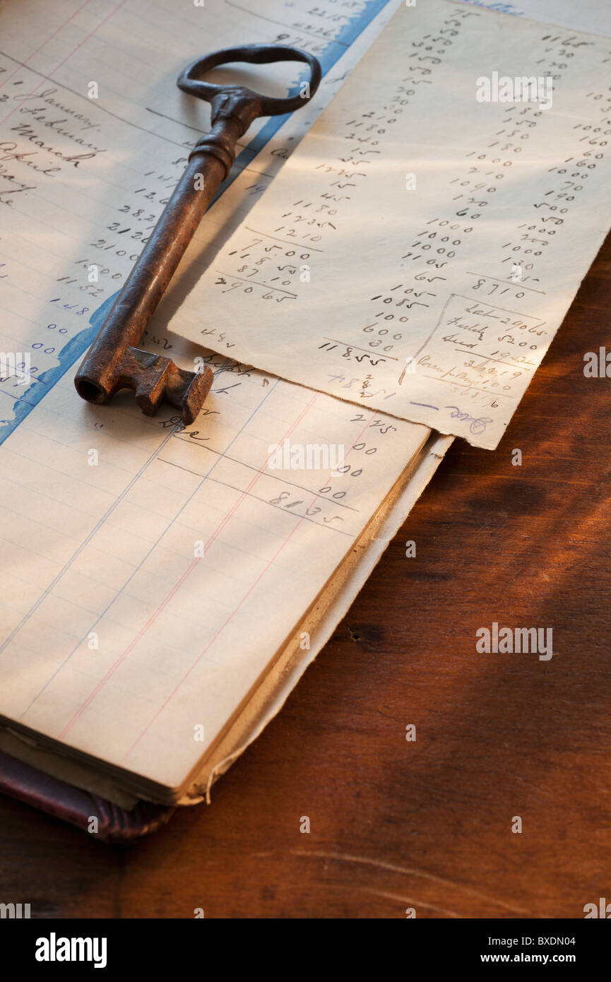 Antique key on top of ledger Stock Photo