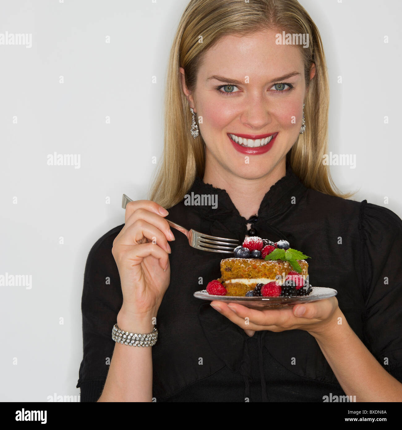 Woman eating decadent dessert Stock Photo