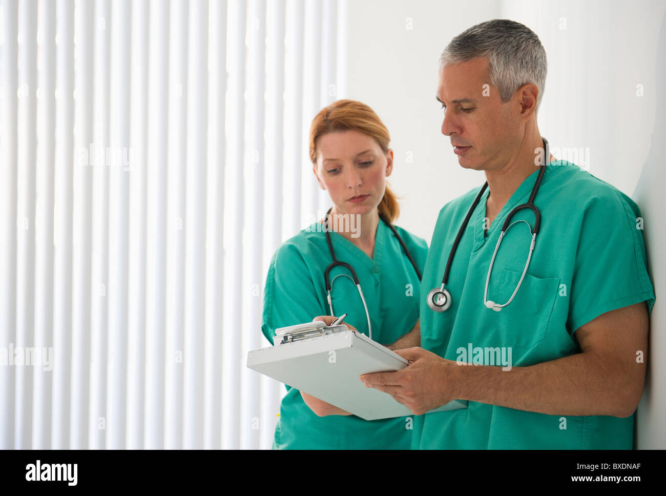 Healthcare professionals looking at medical chart Stock Photo