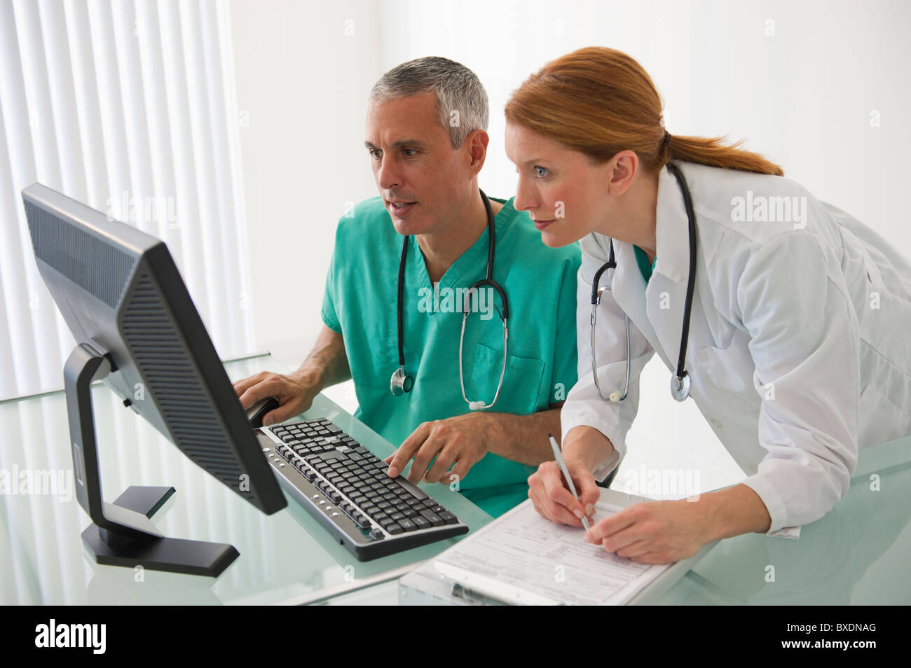 Healthcare professionals looking at computer Stock Photo