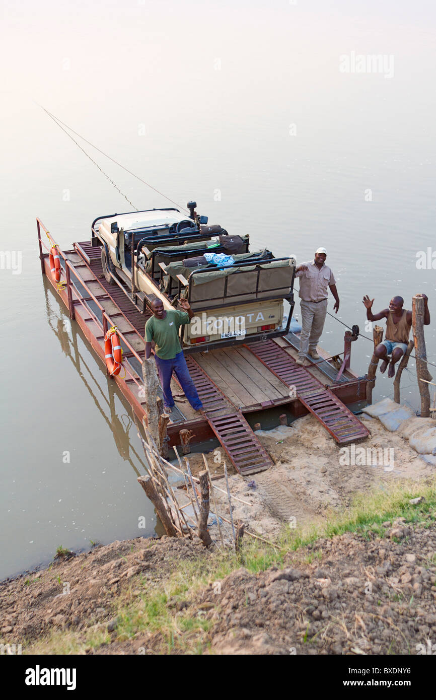 Pontoon boat used to cross Luangwa River. The boat is pulled across the river by hand via a cable. Stock Photo