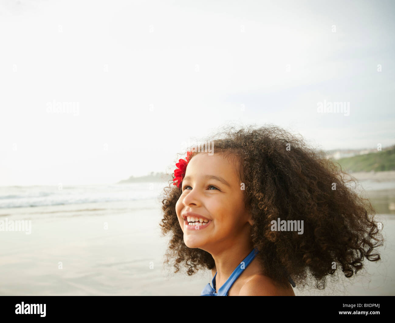 Smiling mixed race girl on beach Stock Photo Alamy