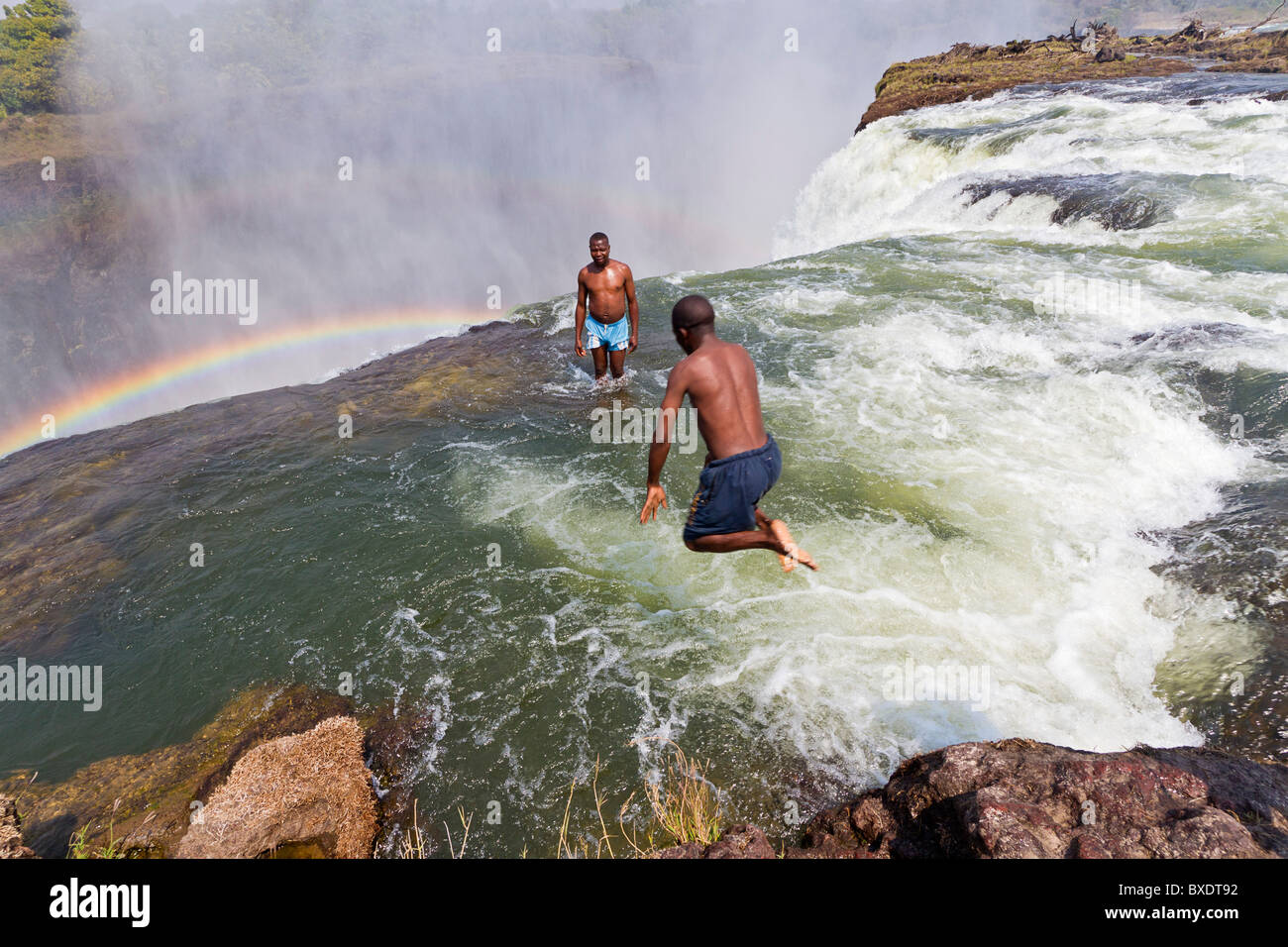Man jumps into Devil's Pool at Victoria Falls Stock Photo - Alamy