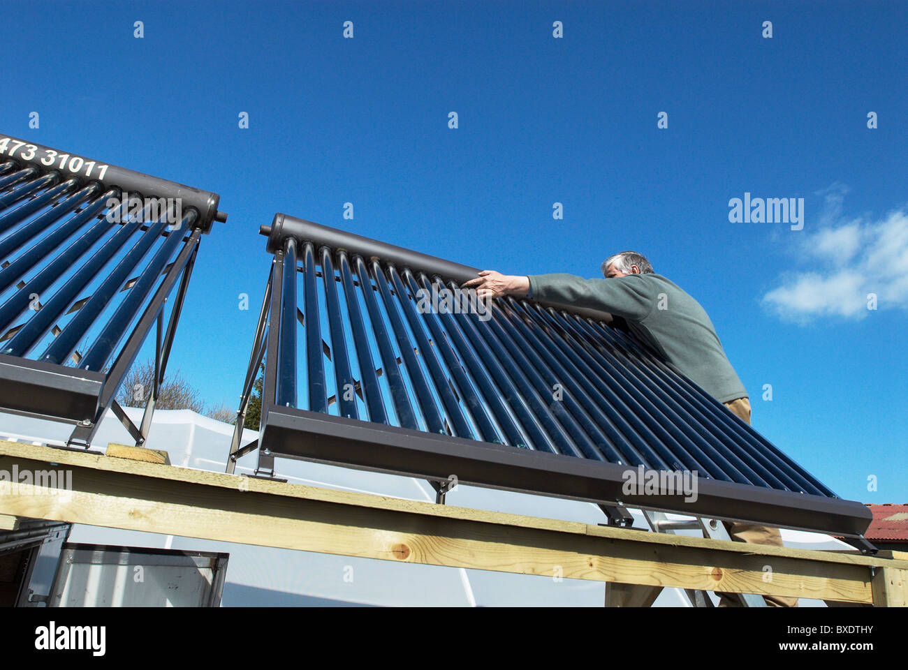 Fitting a hot water solar panel system Stock Photo Alamy