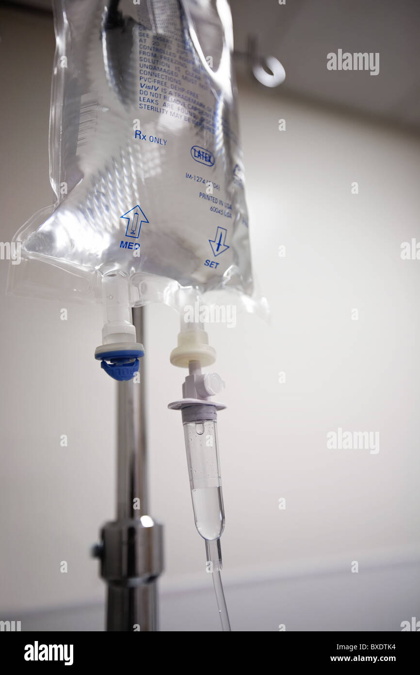 An IV bag on a pole connected to an IV line Stock Photo Alamy