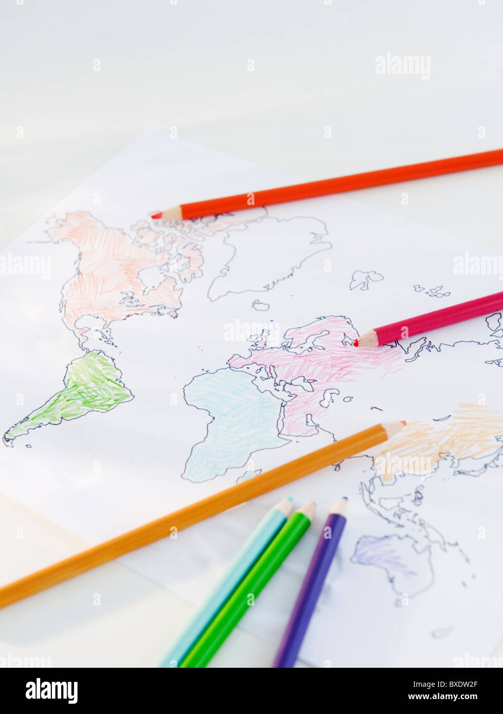 Colored pencils and map of world Stock Photo - Alamy