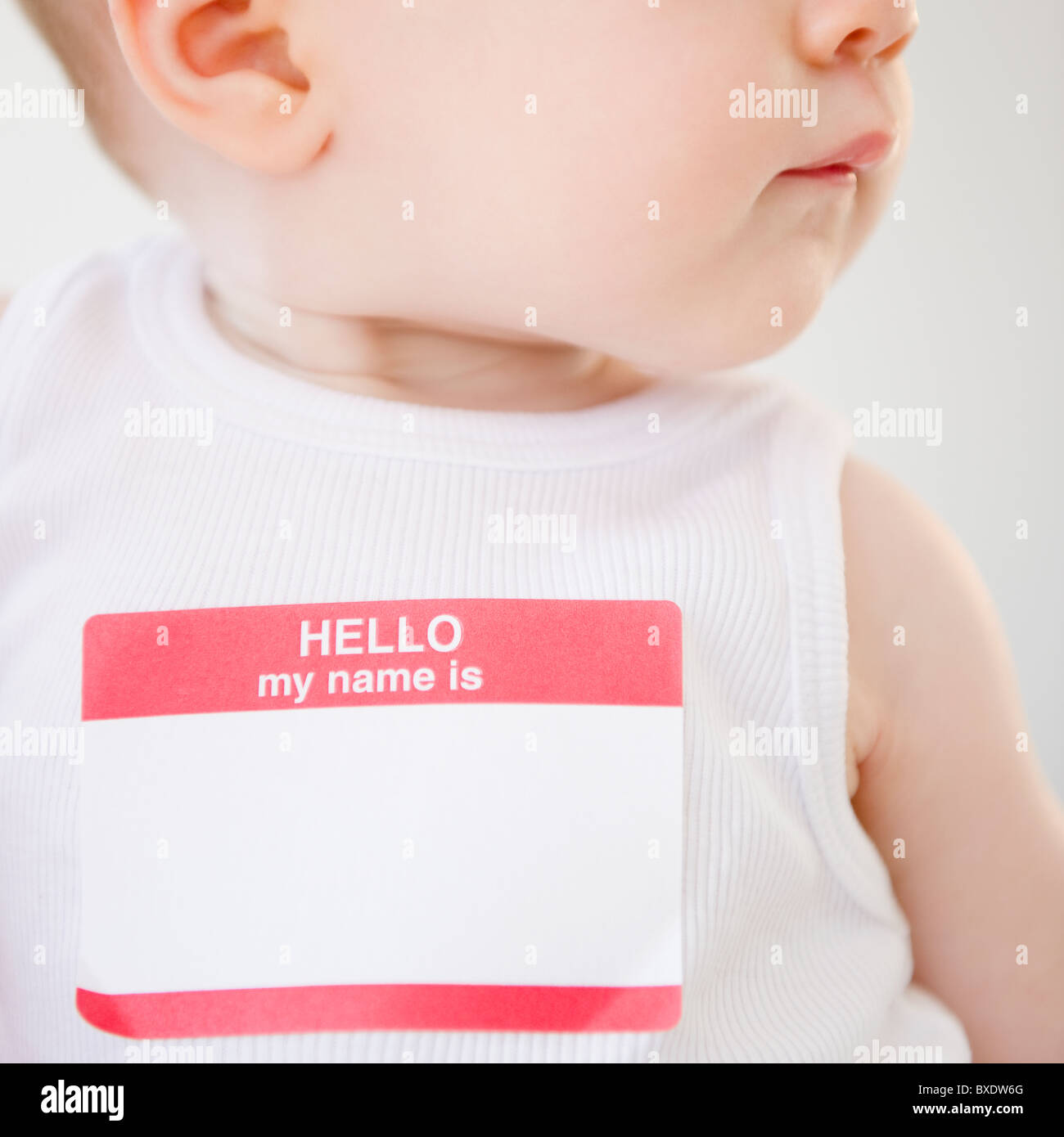 Baby wearing name tag Stock Photo
