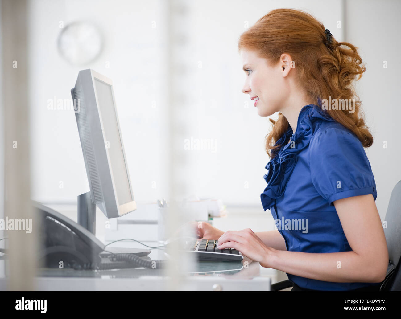Businesswoman working at her desk Stock Photo - Alamy