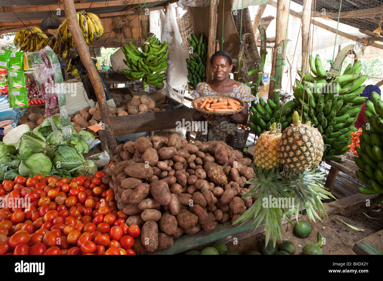 A woman holds a basket of fresh vegetables in the market in Dodoma